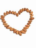 Heart made of nuts of almonds on a white background