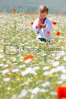 boy in traditional clothes in flowers