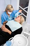 female dentist works with patient at office