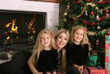 shot of a mother with twin daughters at christmas