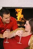 shot of a romantic couple by fireplace vertical