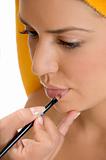 beautician putting lipstick on woman's lips