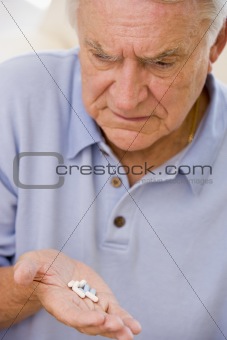 Senior Man Looking At Medicine