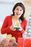 Woman Excited To Open Christmas Present