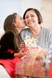 Granddaughter Kissing Grandmother On The Cheek,And Giving Her A 