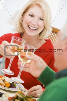 Couple Toasting At Christmas Dinner