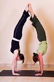 Two beautiful young ladies doing yoga