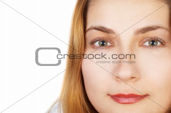 Pretty girl stares out of photo, face closeup. Lot of copy space.