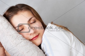 dreaming beautiful young woman lying on pillow