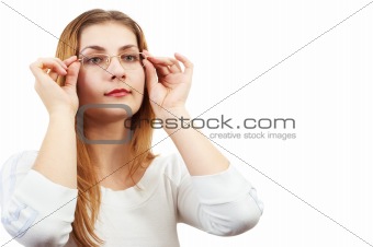 Girl in white looking through glasses, holding it by her hands