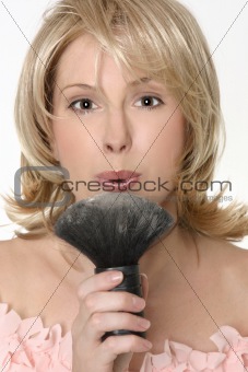 Female flowing excess powder from makeup  brush
