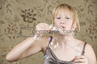 Pretty young girl blowing bubbles
