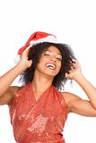 Happy excited ethnic Mrs. Claus in Christmas hat