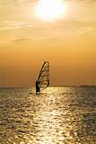 Silhouette of a windsurfer on a sunset