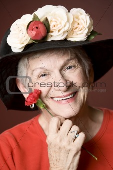 Senior woman in a hat with flowers