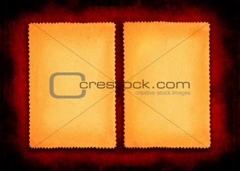 two pieces of yellowed paper on red