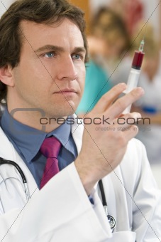Young Doctor With Syringe