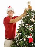 Young Man Decorating Christmas Tree