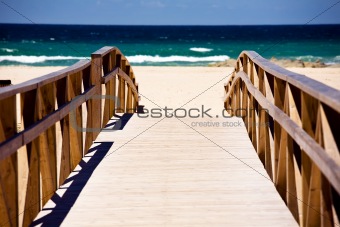 Wooden stairs on deserted beach dunes 