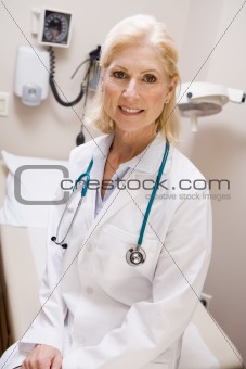 Middle Aged Female Doctor Sitting In A Hospital Ward