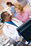 A Doctor And Nurse Discussing Something At The Reception Area Of