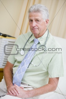 A Doctor Sitting On A Hospital Bed