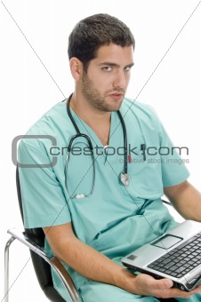 sitting man looking you with laptop