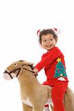 shot of a christmas child riding a pony