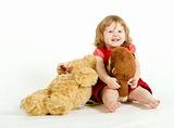 The smiling little girl with plush toys.
