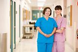 Two Female Nurses Standing In A Hospital Corridor