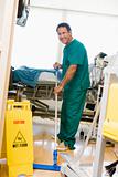 An Orderly Mopping The Floor In A Hospital Ward