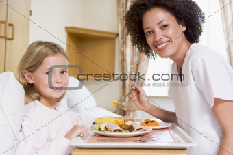 Nurse Feeding Young Girl