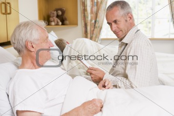 Doctor Checking Up On Senior Man In Hospital