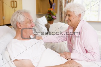 Senior Couple Sitting Together In Hospital