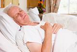 Senior Man Asleep In Hospital Bed