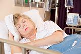 Senior Woman Sleeping In Hospital Bed