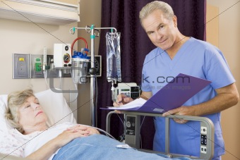 Doctor Making Notes About His Patient