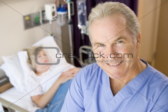 Doctor Standing And Smiling In Patients Room