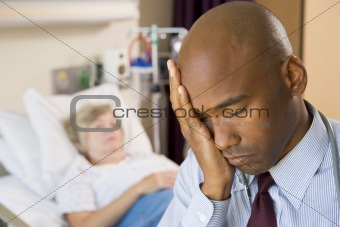 Doctor Looking Tired And Frustrated In Hospital Room
