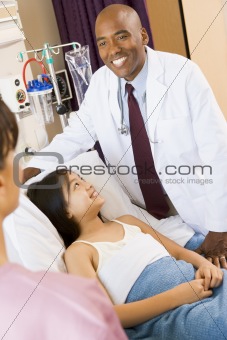 Doctor And Patient Smiling In Hospital Room