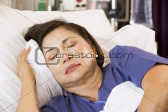 Senior Woman Asleep In Hospital Bed