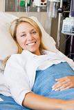 Woman Smiling,Lying In Hospital Bed