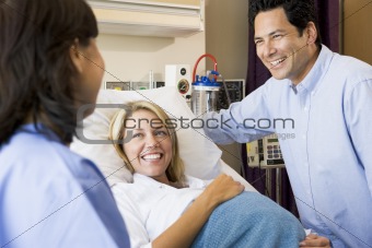 Doctor Talking To Pregnant Woman And Her Husband