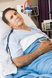 Man Lying In Hospital Bed