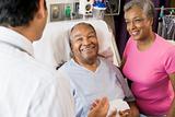 Senior Couple Talking,Smiling With Doctor