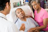 Senior Couple Talking To Doctor,Looking Worried
