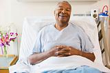 Senior Man Sitting In Hospital Bed,Smiling