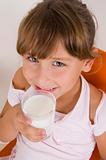 smiling girl with glass of milk