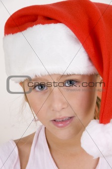 smiling little girl wearing christmas hat