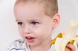 little boy with peeled banana